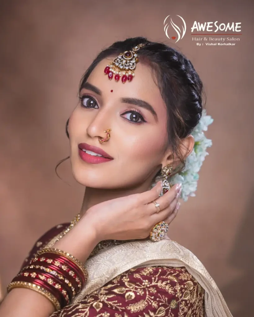 Indian bride with soft glam makeup, defined eyes, and elegant hairstyle styled by Awesome Hair & Beauty Salon