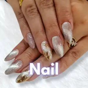 Close-up of elegant bridal nail art featuring long almond-shaped nail extensions with gold and silver glitter designs, rhinestone accents, and glossy finish created by Awesome Hair & Beauty Salon