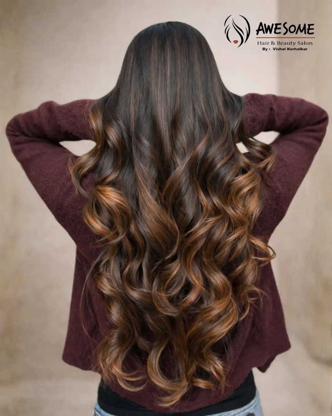 Luxury dark brown balayage with honey caramel highlights and long soft curls at Awesome Hair & Beauty Salon Pune.